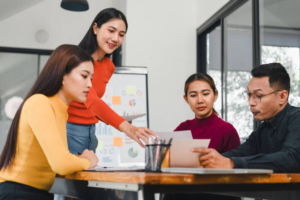 istock Collaborative business meeting with diverse professionals discussing reports. team is engaged, showcasing teamwork and communication in modern office 2197936363
