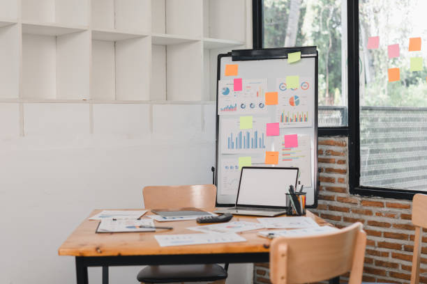 istock modern office workspace featuring wooden table, charts, and sticky notes. environment is bright and organized, ideal for productivity and collaboration 2197936375