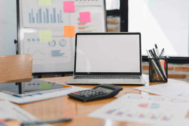 istock modern workspace featuring laptop, calculator, and various charts. setting is organized with colorful sticky notes and documents, ideal for productivity and planning 2197936376