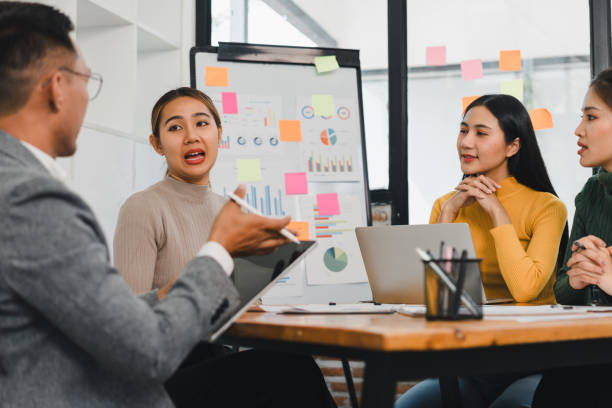 istock Effective team meeting with diverse professionals discussing strategies and ideas. Engaging conversation around data and presentations fosters collaboration and innovation 2197936401