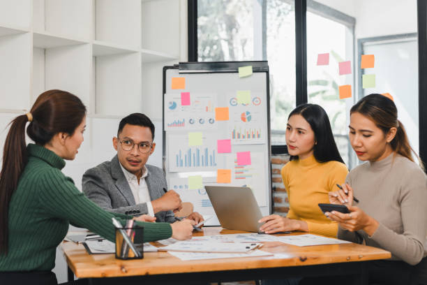 istock Efficient business meeting with diverse professionals discussing strategies, analyzing data, and collaborating on projects in modern office space 2197936403