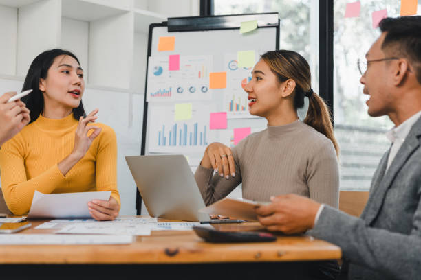 istock Collaborative business meeting with diverse professionals discussing strategies and analyzing data. Engaging conversation and teamwork are evident in this modern office setting 2197936412