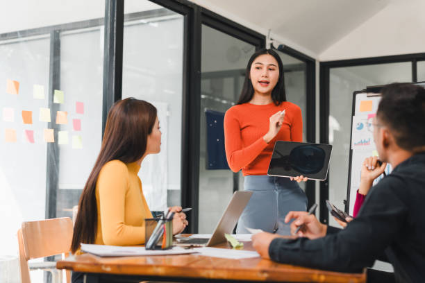 istock Confident woman presenting ideas in modern office meeting 2197936538
