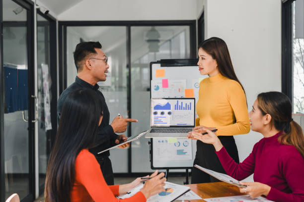 istock Team discussing business charts in modern office meeting 2197936626