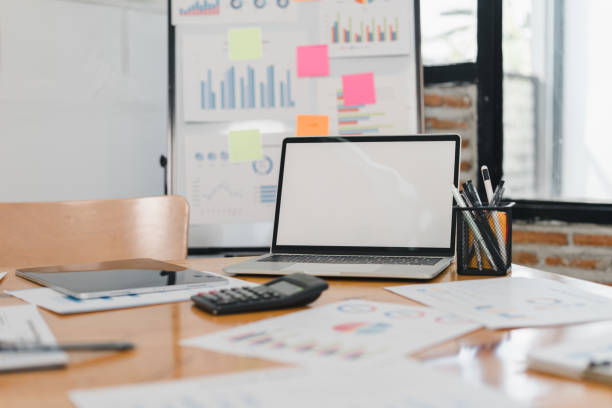 istock Laptop on desk with charts and office supplies 2197936659