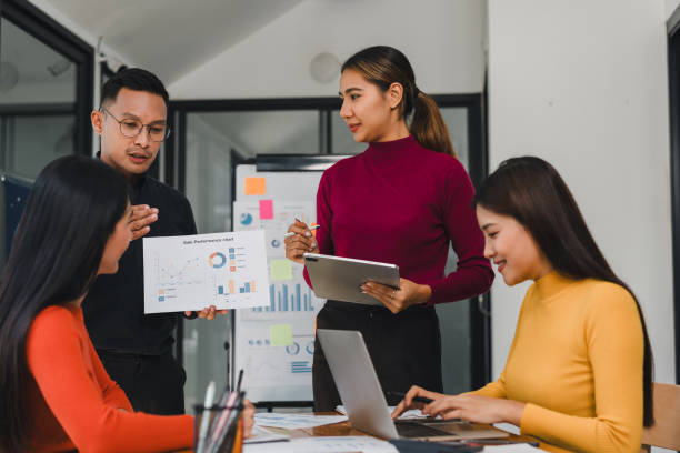 istock Team discussing data with charts and laptops in modern office 2197936660
