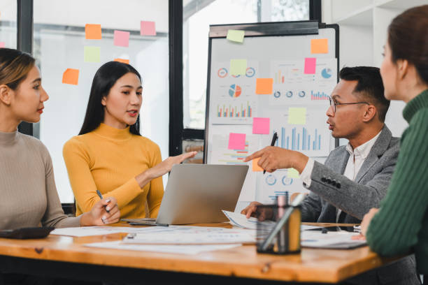 istock Team discussing ideas in modern office meeting room 2197936698