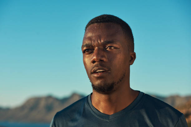 Tired with endurance and health outdoor. Black man, break from running and relax with fitness, vitality and cardio, senior runner in the park.