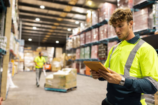 istock Warehouse Workers Engaged in Logistics and Inventory Management with Digital Technology 2197937029