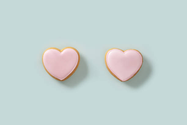 istock Heart shaped pink cookie on blue pastel background. Valentines day card. 2197937549