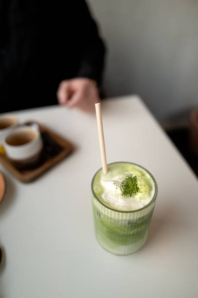 Refreshing iced matcha latte with cream topping