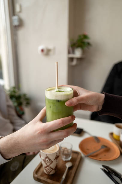 istock Sharing a refreshing green matcha drink at a cafe 2197939437
