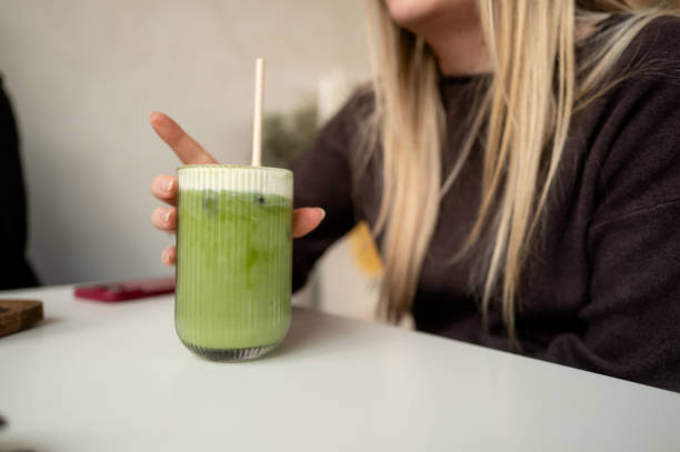 Woman enjoying a refreshing iced matcha latte