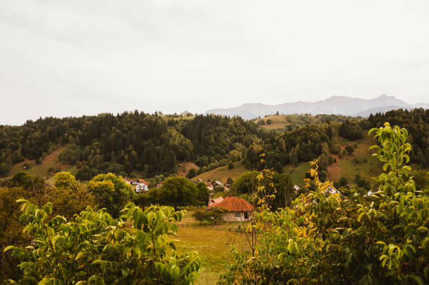 A serene and peaceful countryside scene showcasing picturesque rolling hills alongside charming quaint houses
