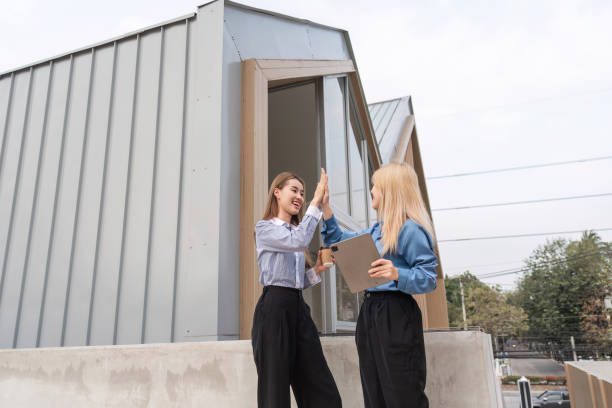 Two female teachers walking in University campus. Business women walking in the street. Pretty smiling female Professor after successful work. Copy space