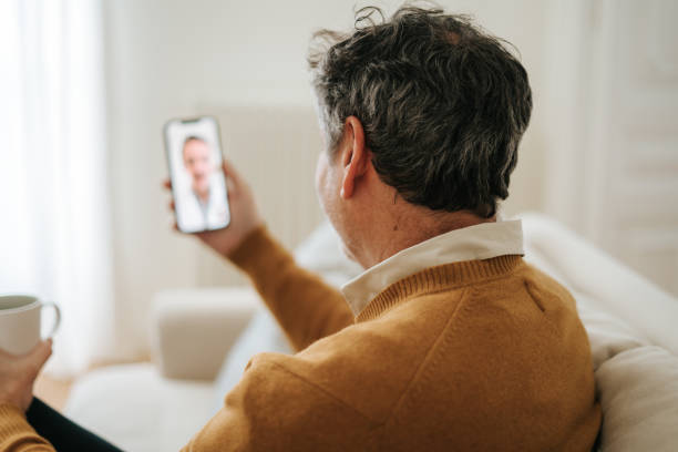 istock Man Having A Doctor's Appointment Online Using Smart Phone 2197941844