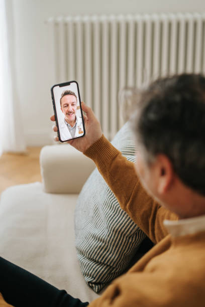 istock Man Having A Doctor's Appointment Online Using Smart Phone 2197941845