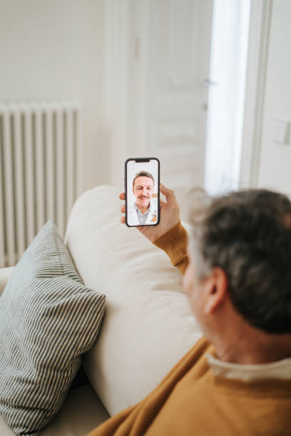 istock Man Having A Doctor's Appointment Online Using Smart Phone 2197941857