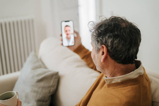 istock Man Having A Doctor's Appointment Online Using Smart Phone 2197941861