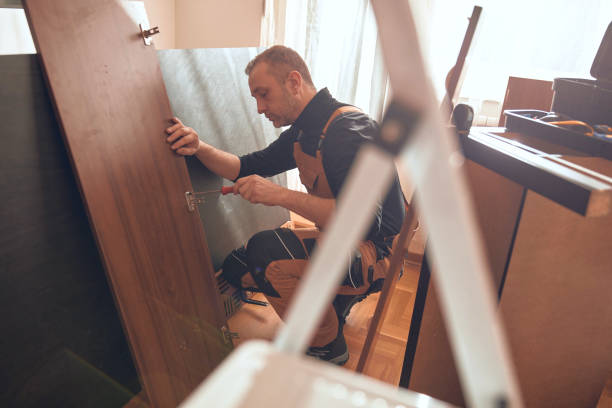 istock Carpenter working and assembling furniture in a new apartment. 2197941883