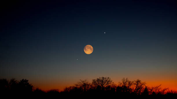 istock Full Moon, stars, planets and landscape scenery silhouettes. 2197942042