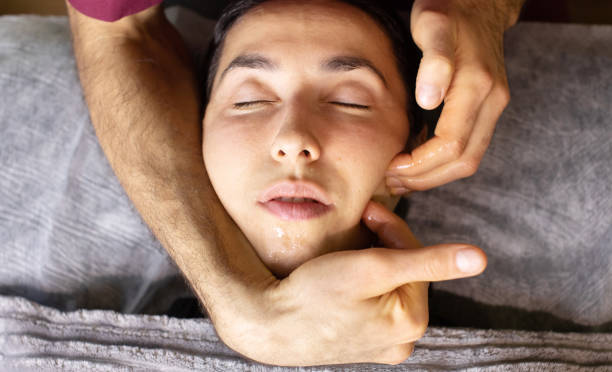 istock woman is getting a massage on her face. 2197944428