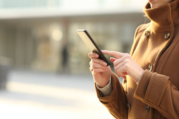 istock Closeup of a woman hand using smartphone in winter 2197945164
