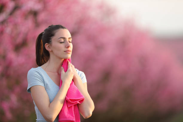 istock Sportswoman drying sweat with a towel in nature 2197946029