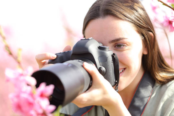 istock Woman using dslr camera to take macro photo 2197946104