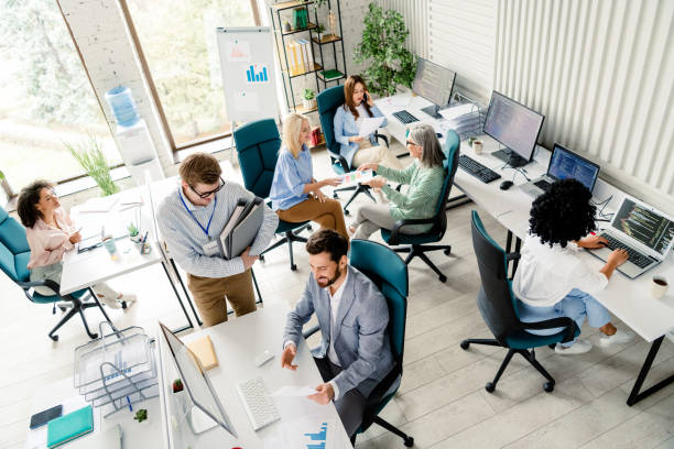 istock Group of professionals collaborating and working in a modern office setting with technology 2197946251
