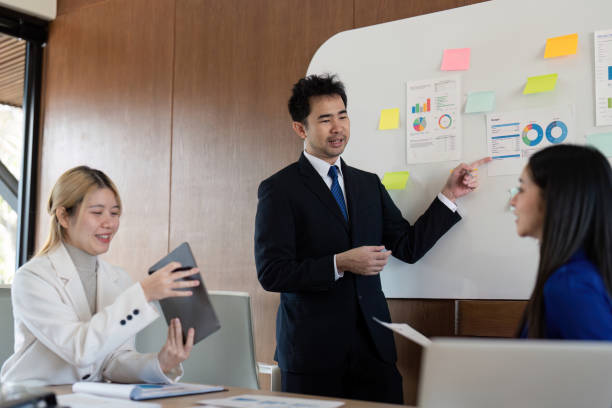 istock Diverse business team presenting financial analysis and insights in a modern office environment. 2197946389