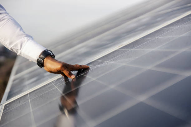 istock Close up of multicultural environmentalist's hand touching solar panels. 2197949626