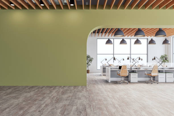 istock Semi-empty office interior with arched olive green wall and copy space,  a wooden slats ceiling, work desks and large windows, on wood look tiled floor 2197953767