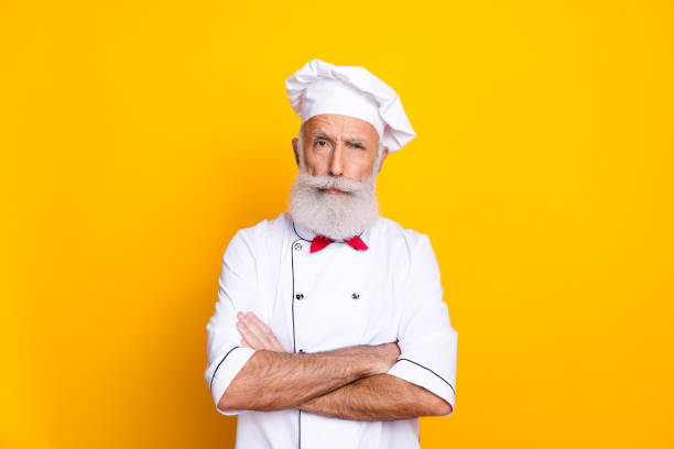 Cook chef in white uniform. Bearded man chef. Bearded man restaurant worker. Professional cook. Culinary concept. National cuisine. Restaurant menu. Lunch meal. Restaurant dish. Delicious dessert.