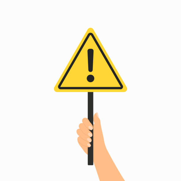 istock Hand Holding Warning Sign With Exclamation Mark Symbol. Alertness, Danger And Hazard Sign 2197953958