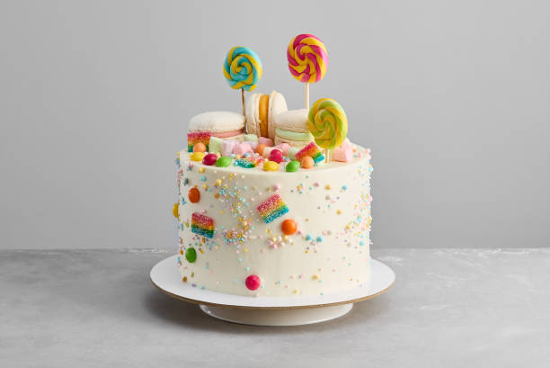 istock Whimsical Childrens Cake with Macarons, Lollipops, and Colorful Candy Delight 2197955941