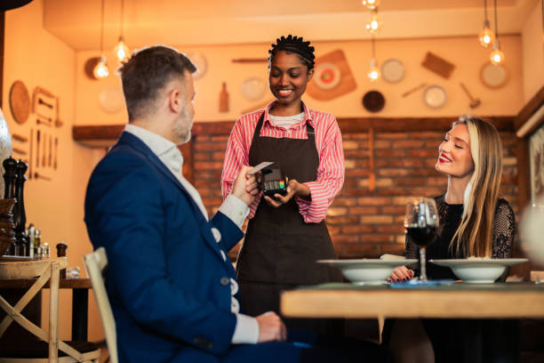 istock Elegant man paying with a credit card for a dinner at the restaurant 2197956180