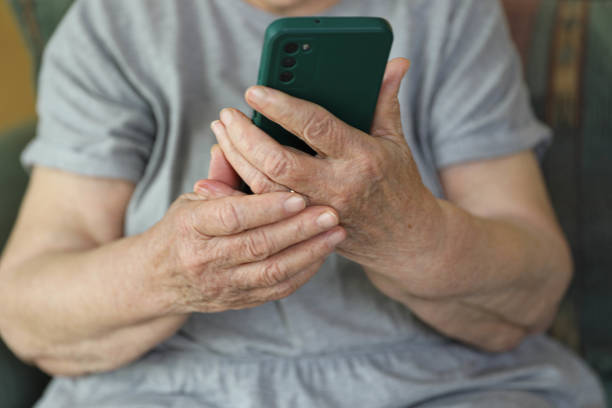 istock Elderly woman with smartphone, 80 + 2197956536