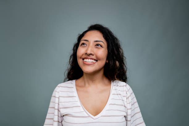 istock Young woman contemplating on a gray background 2197958082