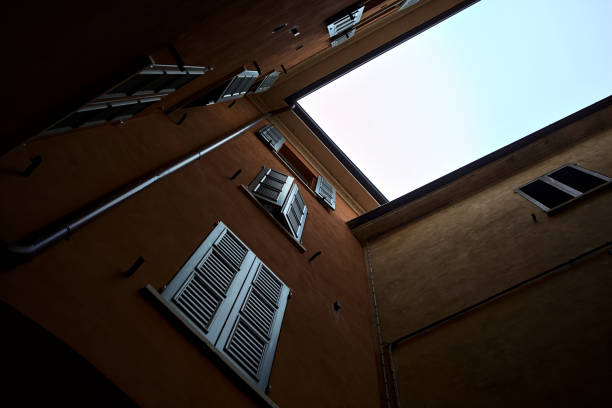 Building  seen from below with a cloudy sky in the background
