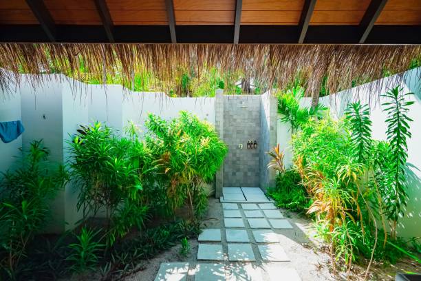 istock Serene outdoor shower with lush greenery. 2197958441