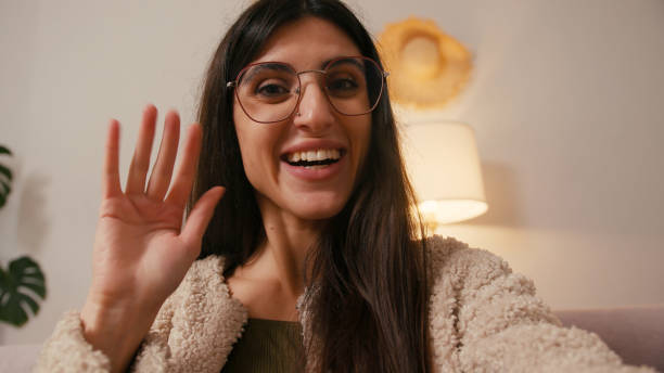 istock Cheerful young woman records video message from home 2197959903