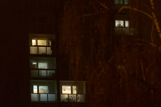 istock A tall building with numerous windows shining brightly is lit up at night 2197963891
