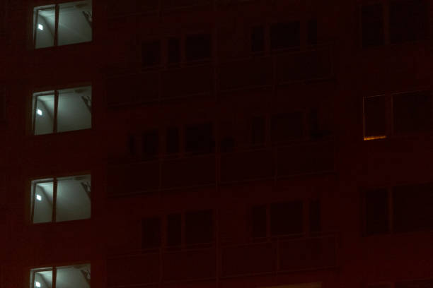 istock A tall building filled with numerous windows shines brightly at night 2197964537