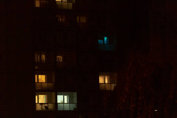 istock Blurry picture of a building with many lit windows at night 2197964867