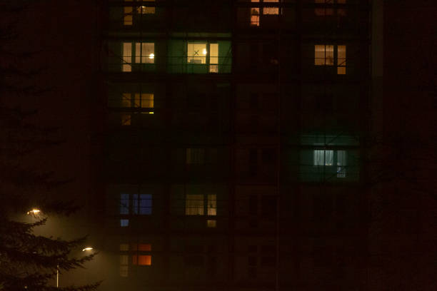 istock A tall building with numerous windows is brightly lit up during the night 2197965675