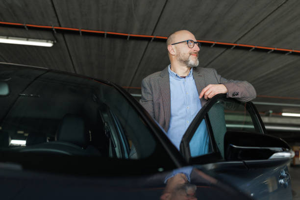 istock Mature man entering his car 2197965755