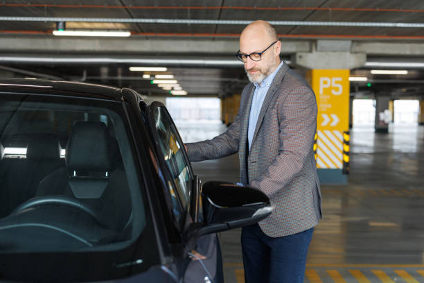 Photo of a successful professional getting into his car