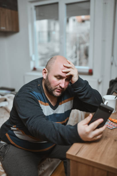 istock Overweight Male Looking Tired After Having Headache All Day Dealing With Virus 2197967523