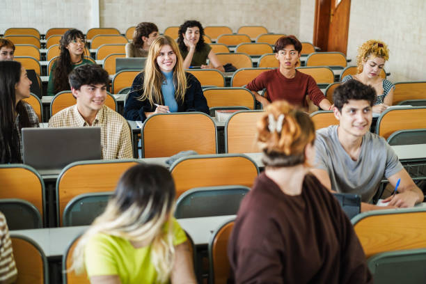 istock Students inside university class room - Back to school, campus lifestyle and multiracial concept - Main focus on center blond girl face 2197968816